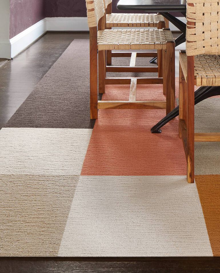 Detail of FLOR Made You Look dining room area rug shown in Pearl, Coral, Beige, Mink, Tawny, and Copper